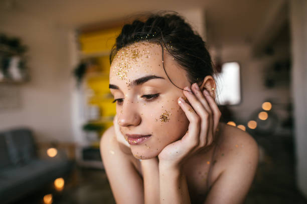 Young woman with golden glitter on the face